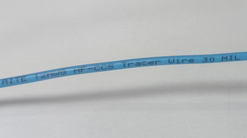 Blue AITE CCS tracer wire with product identification printed on insulation