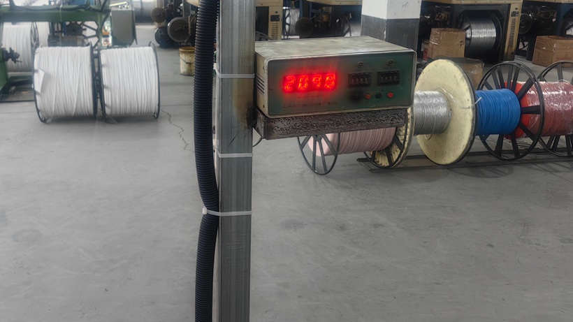 Factory length counter with reels and winding machinery in background